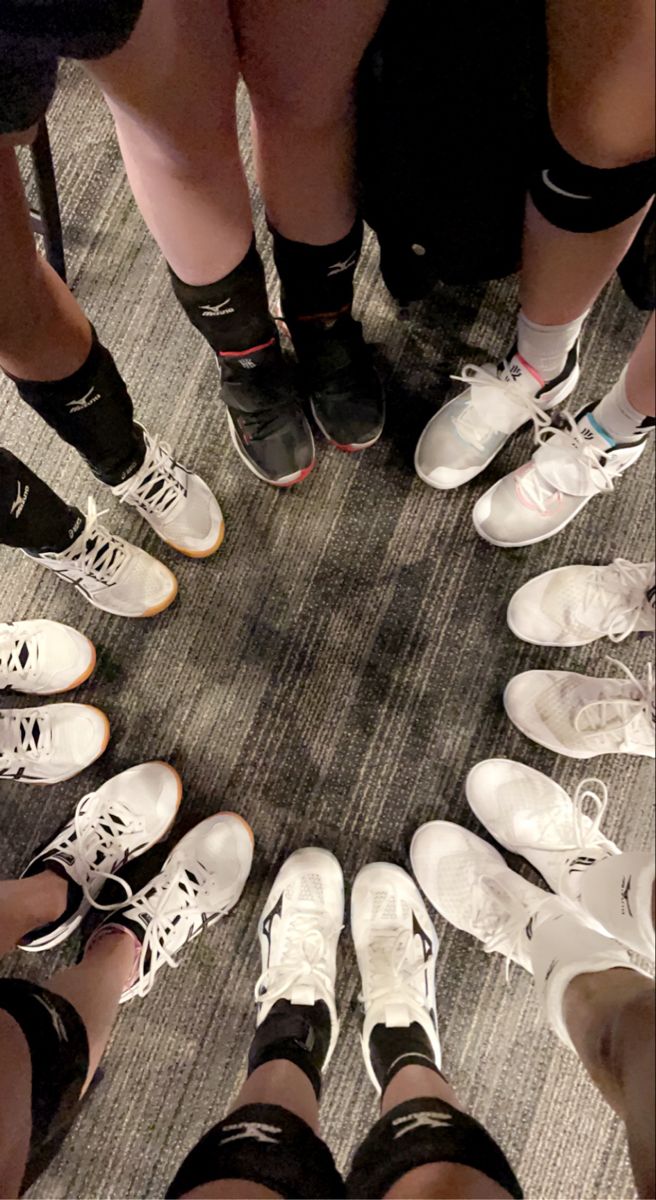 a group of people standing in a circle with their feet on each other's ankles