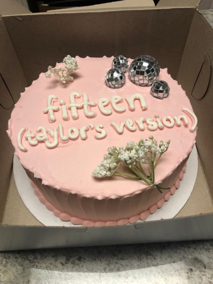 a pink cake in a box that says fifteen year's vision on the side