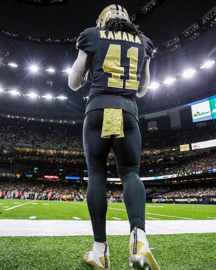 a football player standing on top of a field