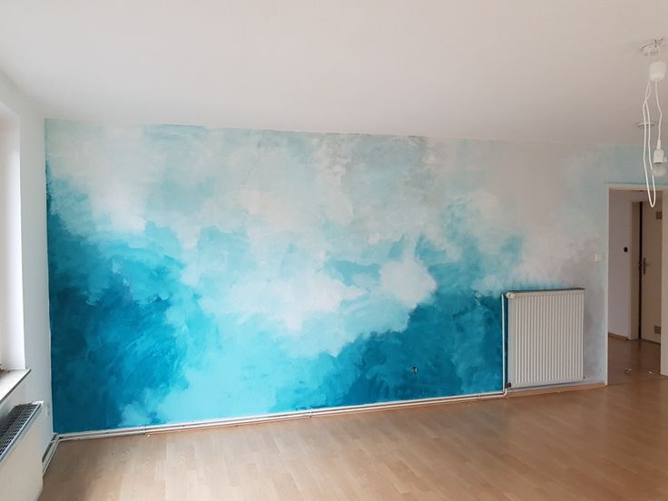 an empty room with blue and white paint on the walls