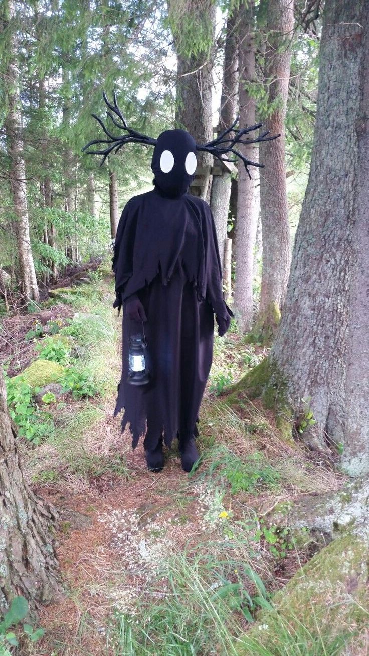 a person in a costume walking through the woods