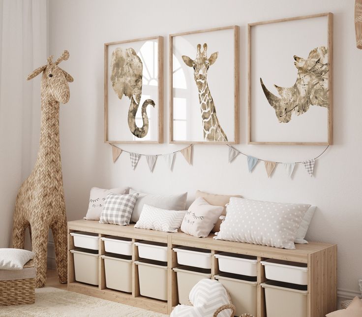 there are three giraffes hanging on the wall in this room with white walls