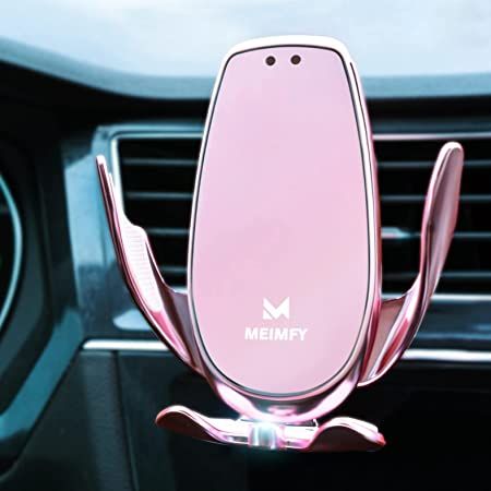 a pink phone holder in the middle of a car dashboard with an emblem on it