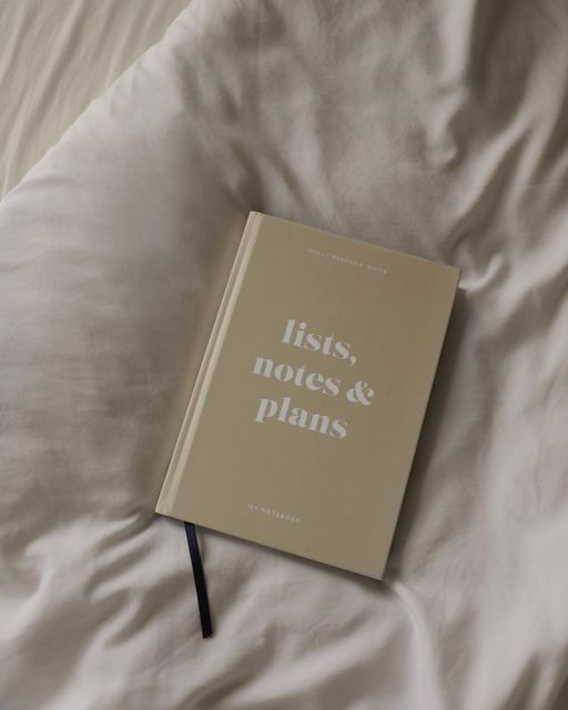 a book sitting on top of a white bed