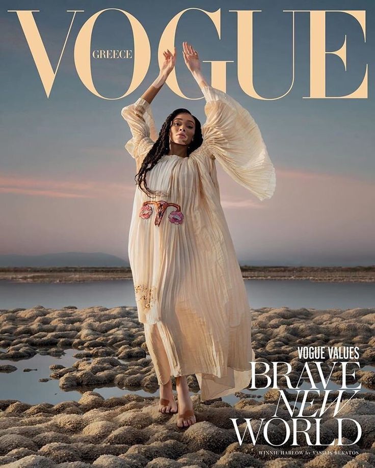 a woman in a white dress on the cover of a magazine with her hands up