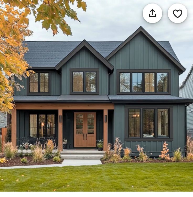 a large house with lots of windows in the front yard