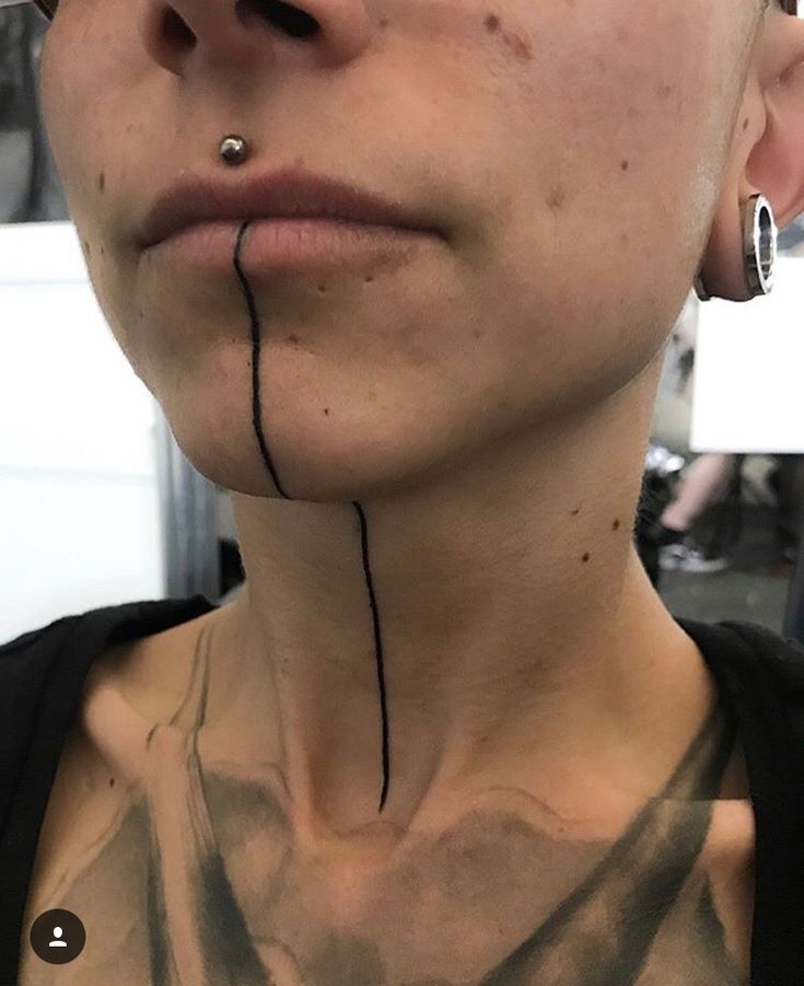 a woman with piercings on her nose and neck