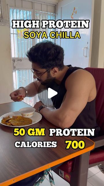 a man sitting at a table eating food with the caption high protein soya chili