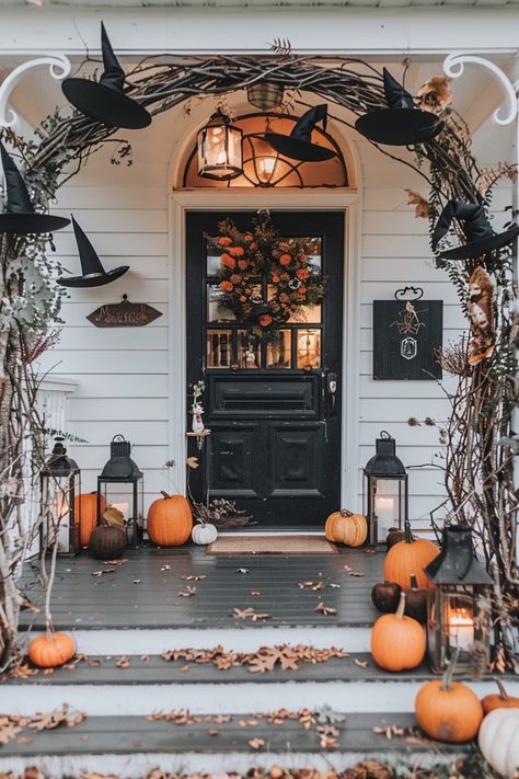 a front porch decorated for halloween with pumpkins and candles