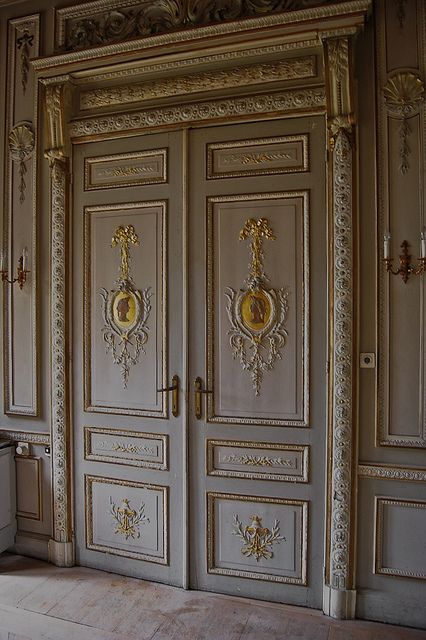 an ornately decorated room with two large doors