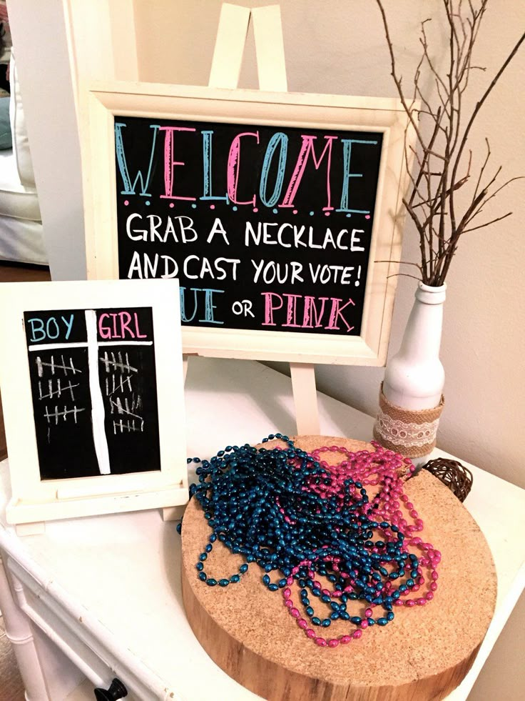 an image of a welcome sign and some beads on a wooden board next to a chalkboard