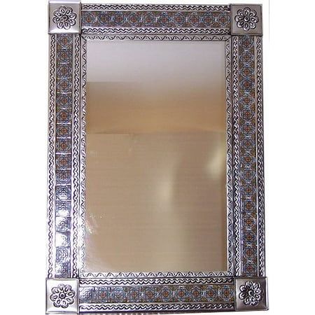 an ornate silver framed mirror on a white wall