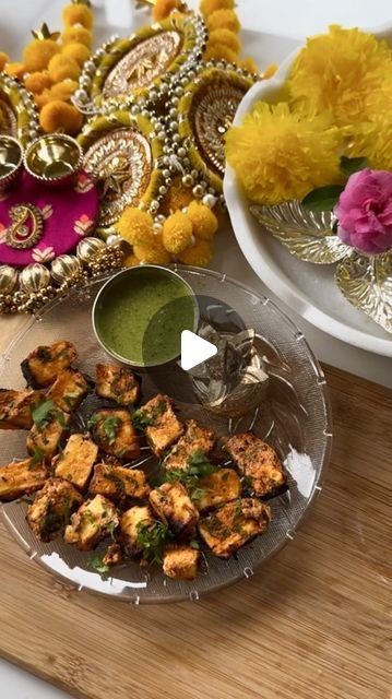 the plate is full of food and there are flowers on the table next to it