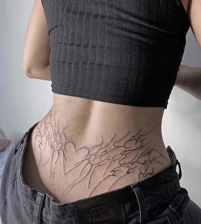 a woman's stomach with an intricate tattoo on her lower body and bottom part