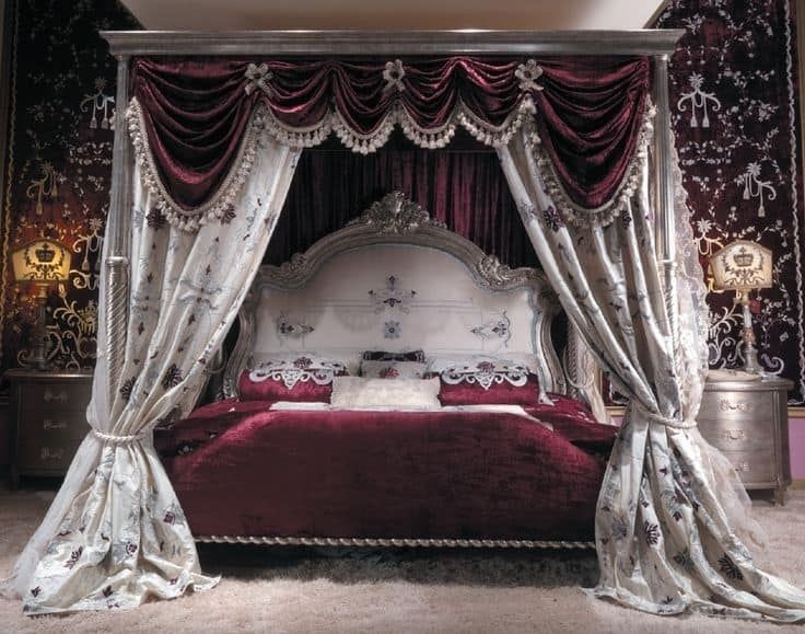 the canopy bed is made up with red and white drapes on it's sides