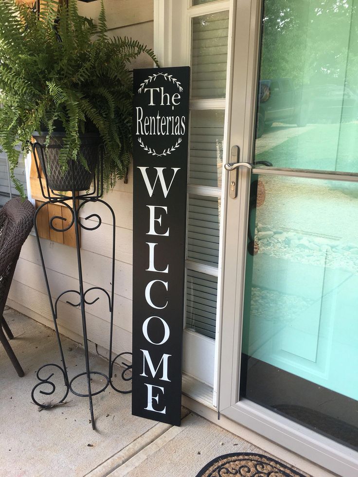 a welcome sign on the front porch of a house