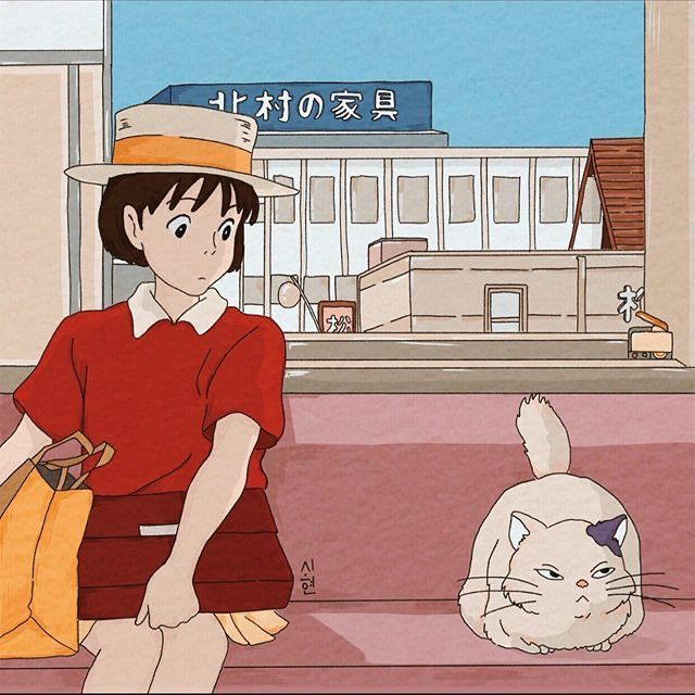 a woman sitting next to a cat on top of a floor in front of a building