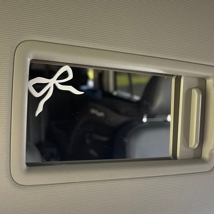 the interior of a car with a bow sticker on it