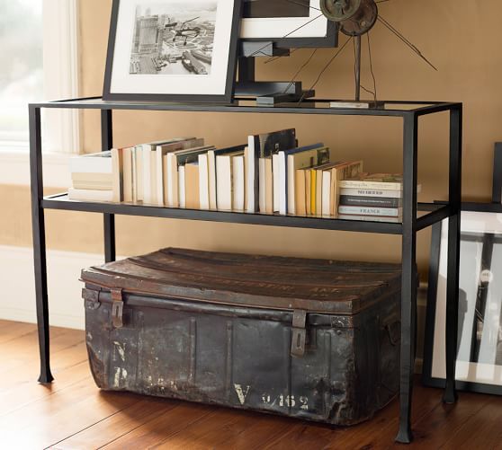 an old trunk is next to a shelf with books