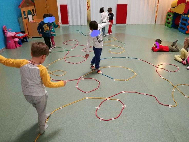 several children are playing with toys in a room