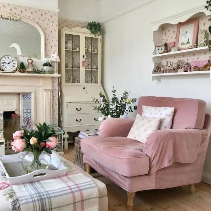 a living room filled with furniture and flowers on top of a wooden floor next to a fire place