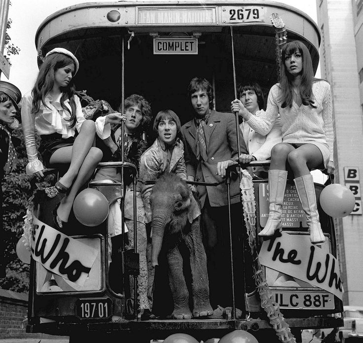 a group of people sitting on the back of a bus