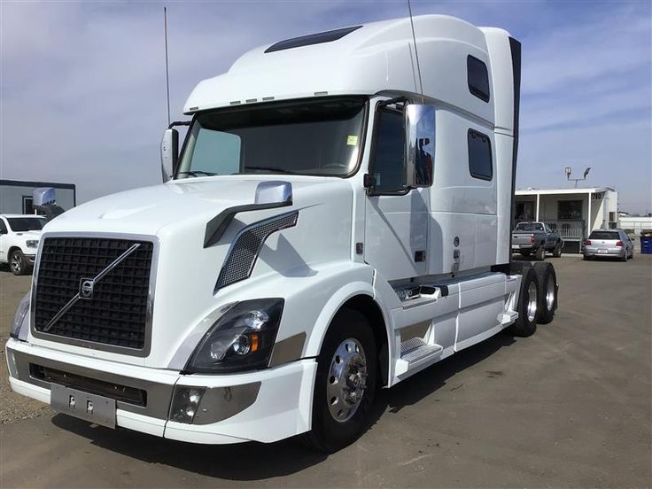 a white semi truck parked in a parking lot