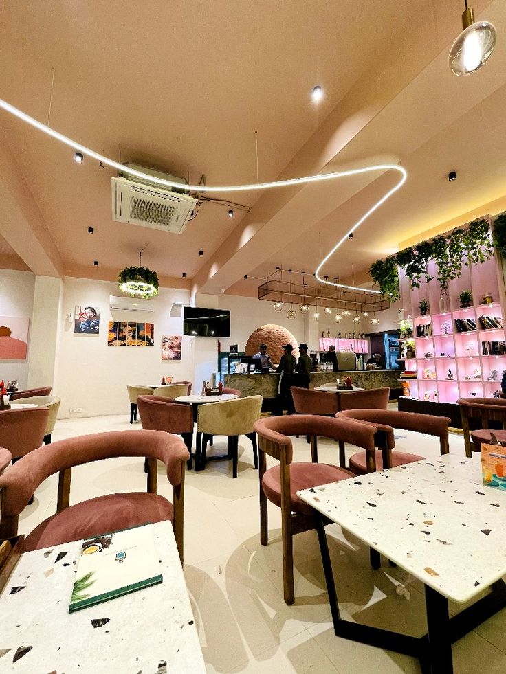 the interior of a restaurant with tables and chairs