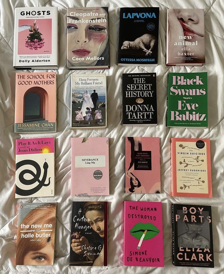 there are many different books on the bed together, including one that is pink and black