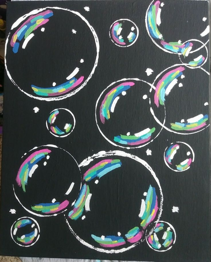 an image of soap bubbles painted on black paper