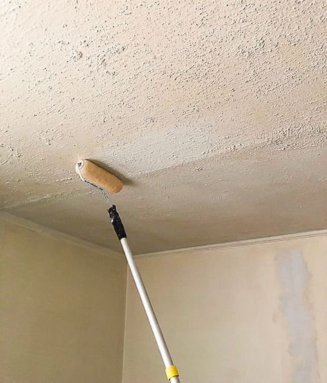 a mop is hanging from the ceiling in a room that has been painted white