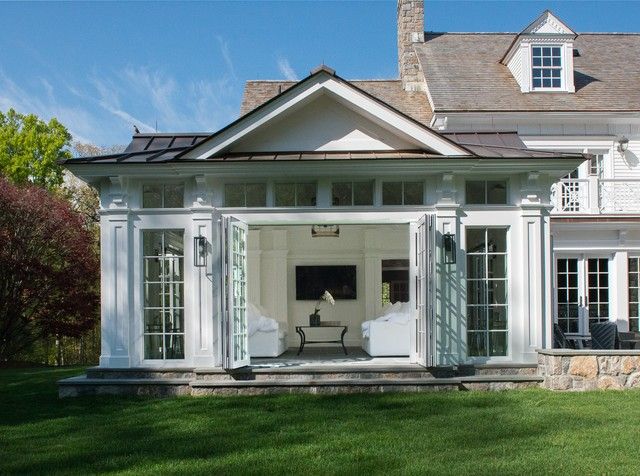 a large white house sitting on top of a lush green field