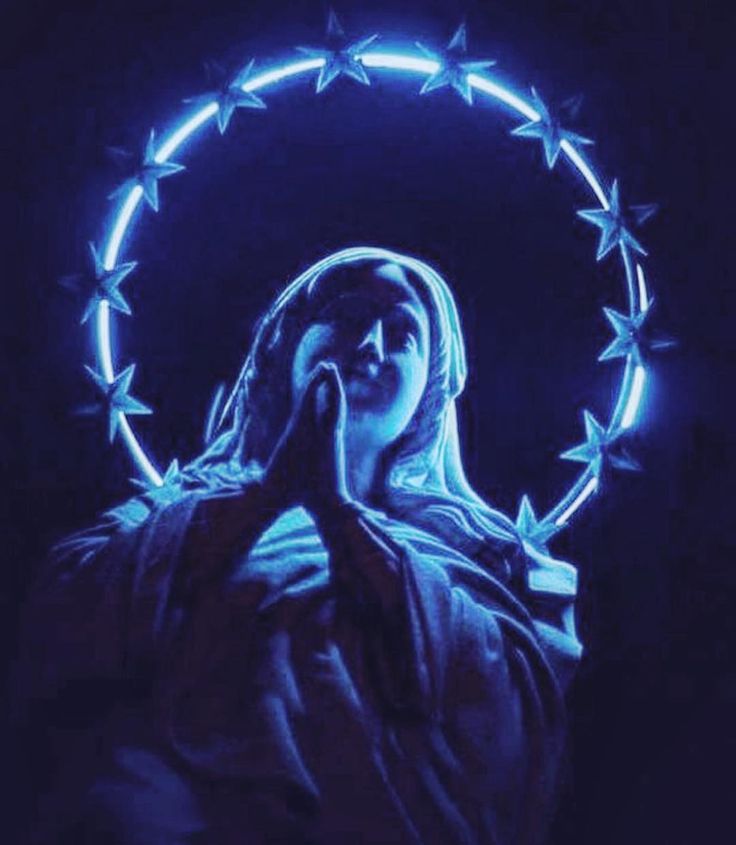 the statue is illuminated with blue lights and surrounded by starbursts, it appears to be praying