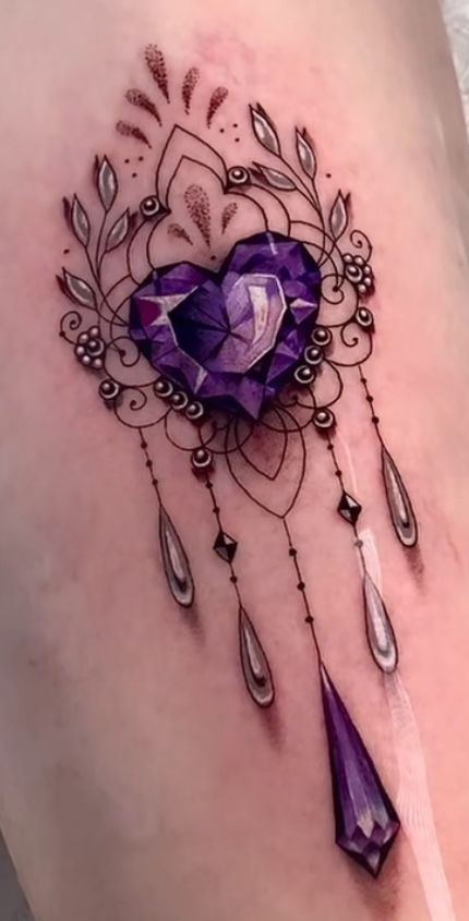 a woman's thigh with a purple heart and diamond tattoo design on the side