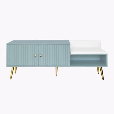 a blue and white sideboard with two drawers on each side, one drawer open to reveal a bed