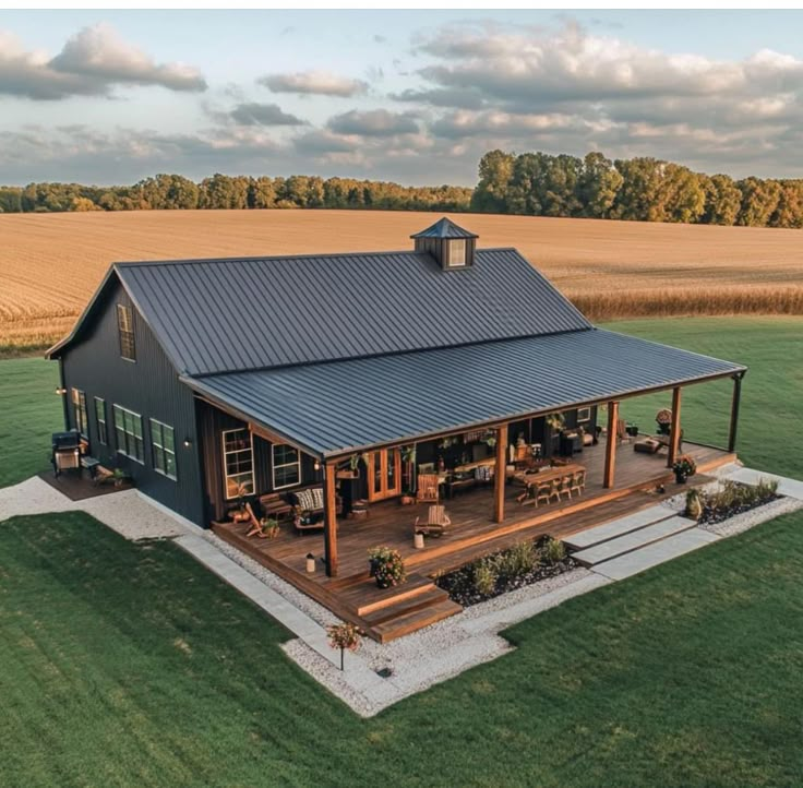 an aerial view of a house in the middle of a field