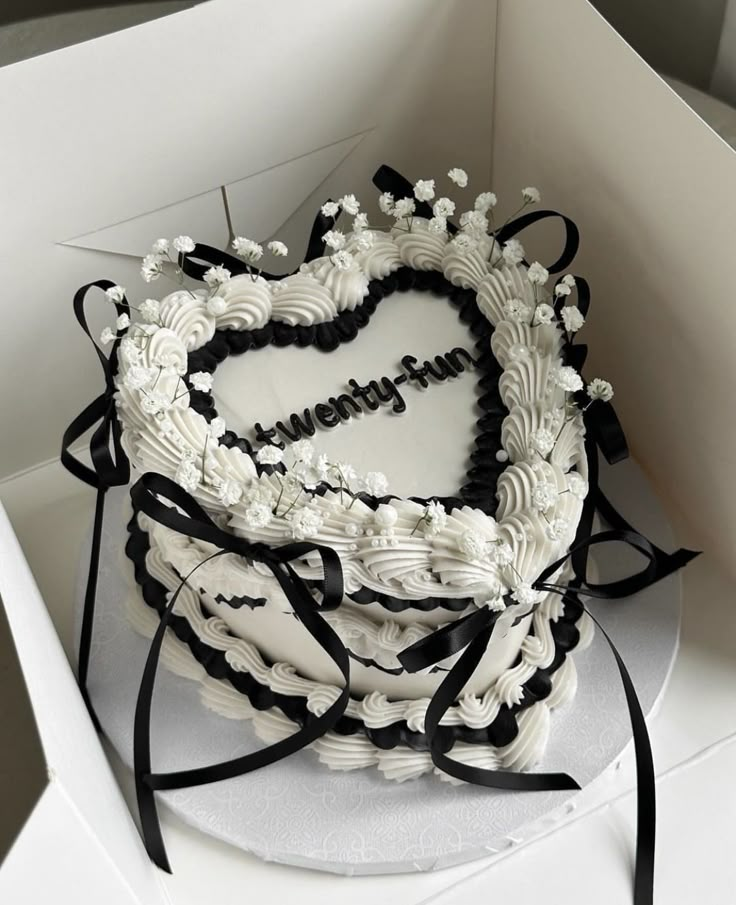 a heart shaped cake in a white box