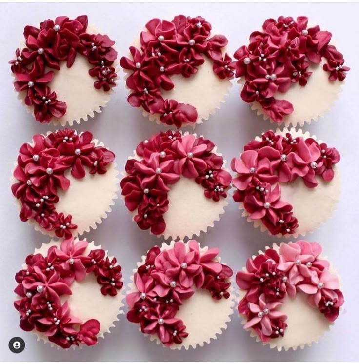 cupcakes decorated with pink and white icing are arranged in the shape of flowers