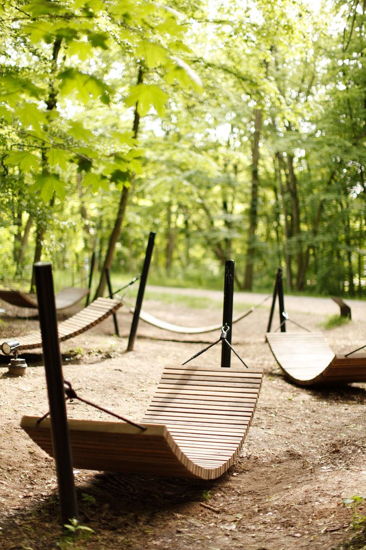 several hammocks in the middle of a wooded area