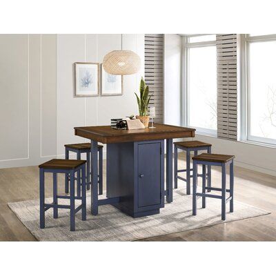 a kitchen island with four stools and a table in front of the counter top