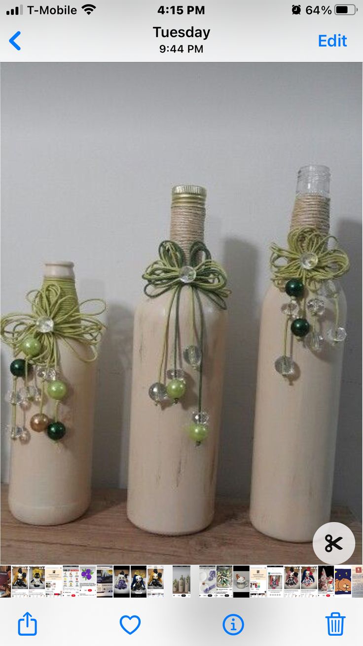 three wine bottles decorated with bows and pearls