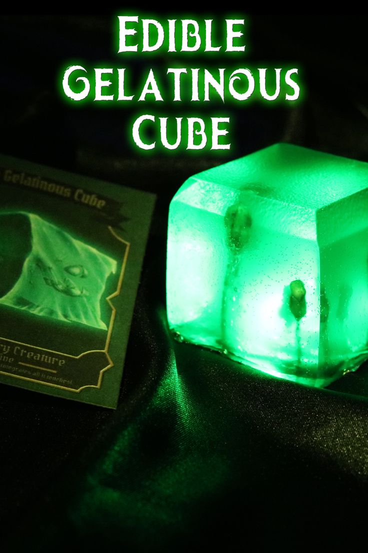 an ice cube with the words edible gelatinous cube on it next to a book