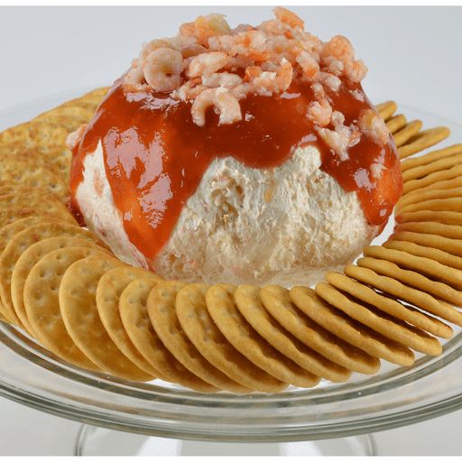 a plate with crackers, cheese and sauce on it