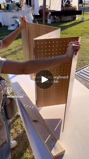 a woman standing next to a wooden board