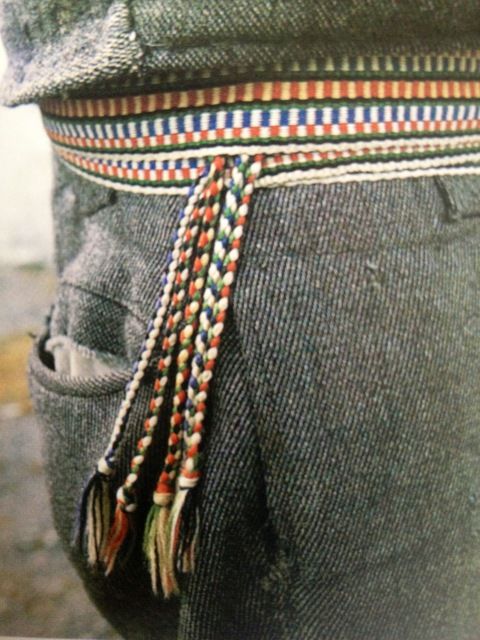 the belt is decorated with multicolored beads and tassels on it's waist