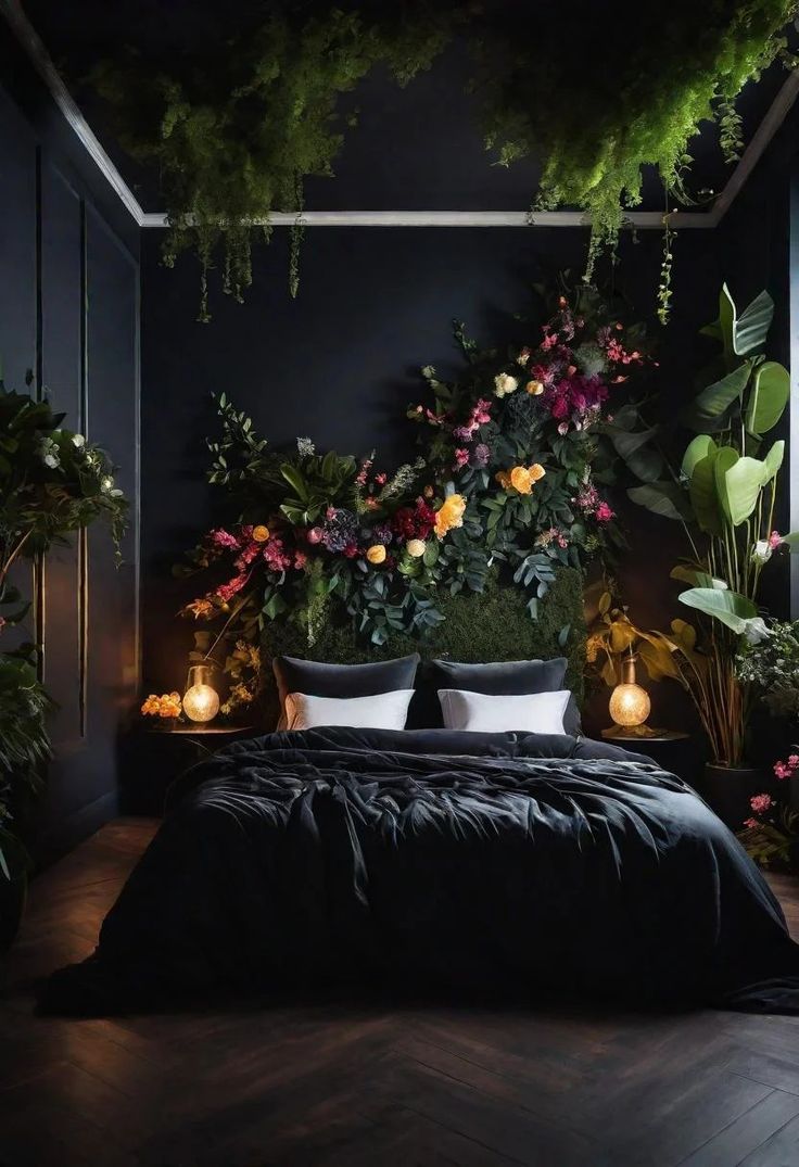 a bed with black sheets and pillows surrounded by plants, candles and potted plants