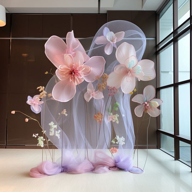 a group of flowers sitting inside of a glass vase on top of a white floor