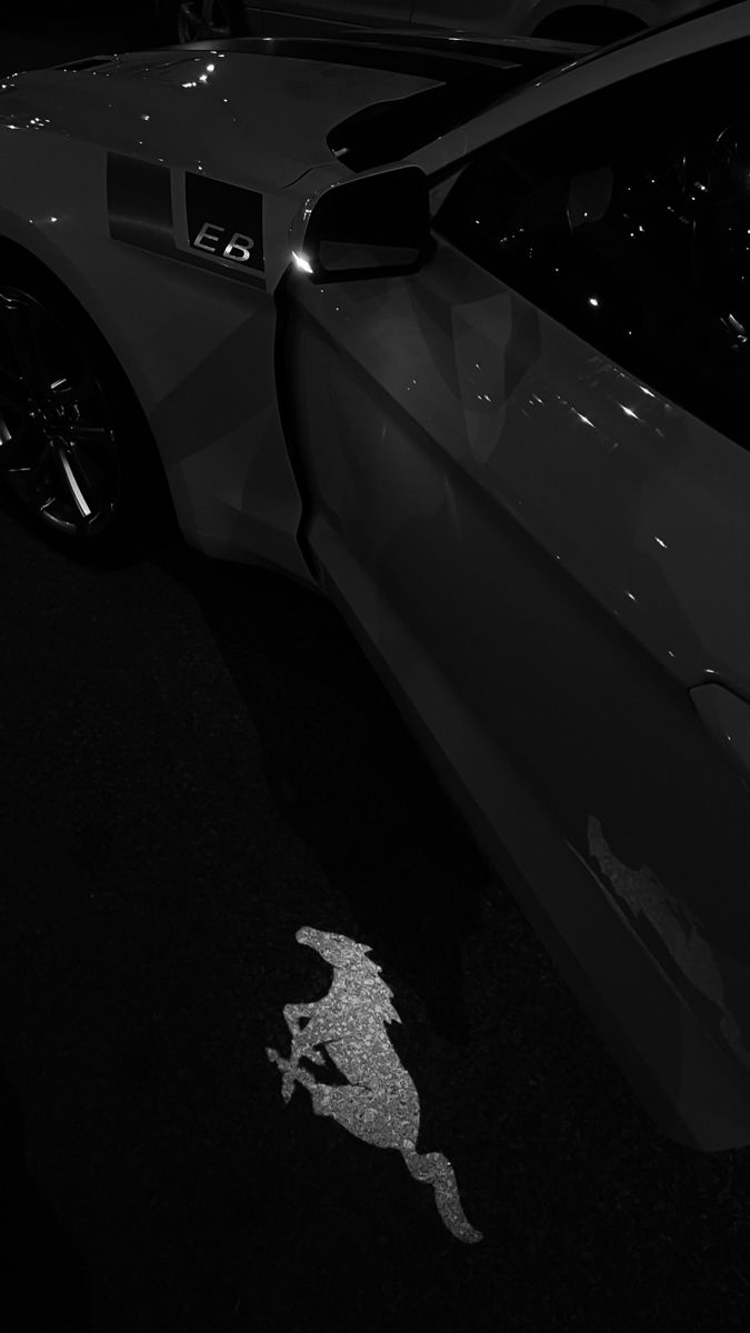 a black and white photo of a sports car