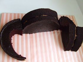 a chocolate cake is cut into pieces on a pink and white striped paper