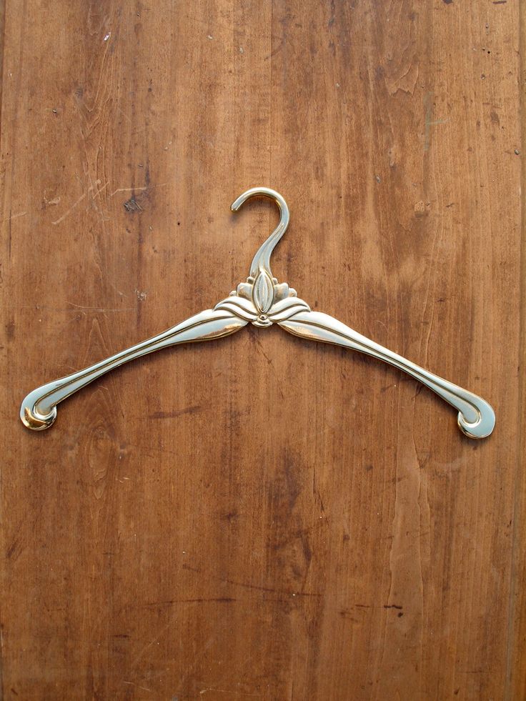 a metal hanger sitting on top of a wooden table